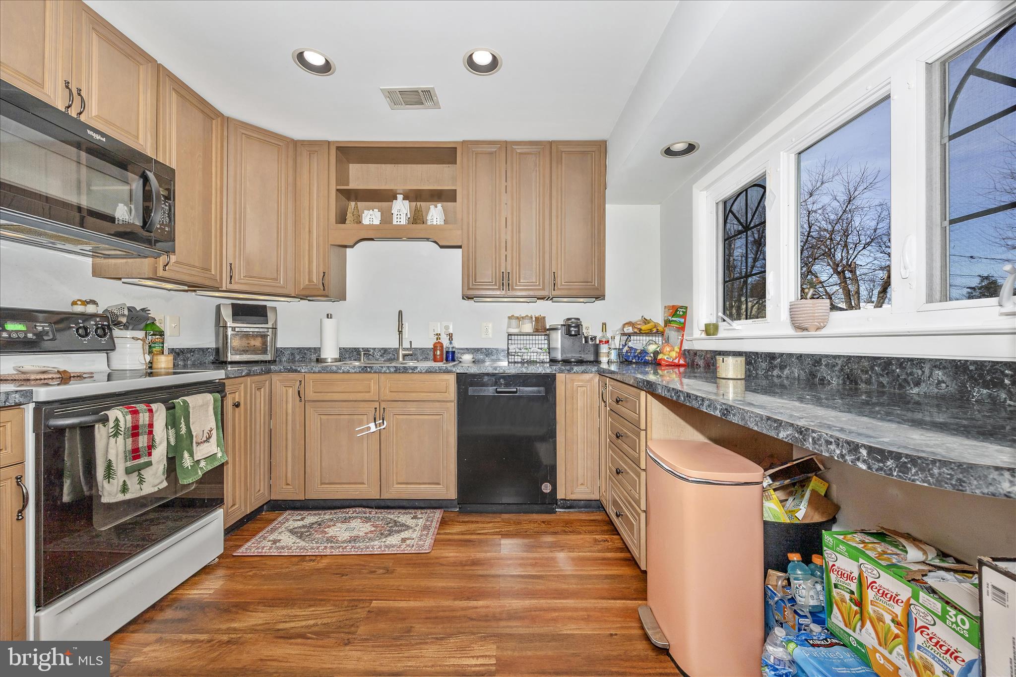 439 Center Street Frederick, MD 21701 - Photo 22 of 49 a kitchen with granite countertop a stove top oven sink and cabinets