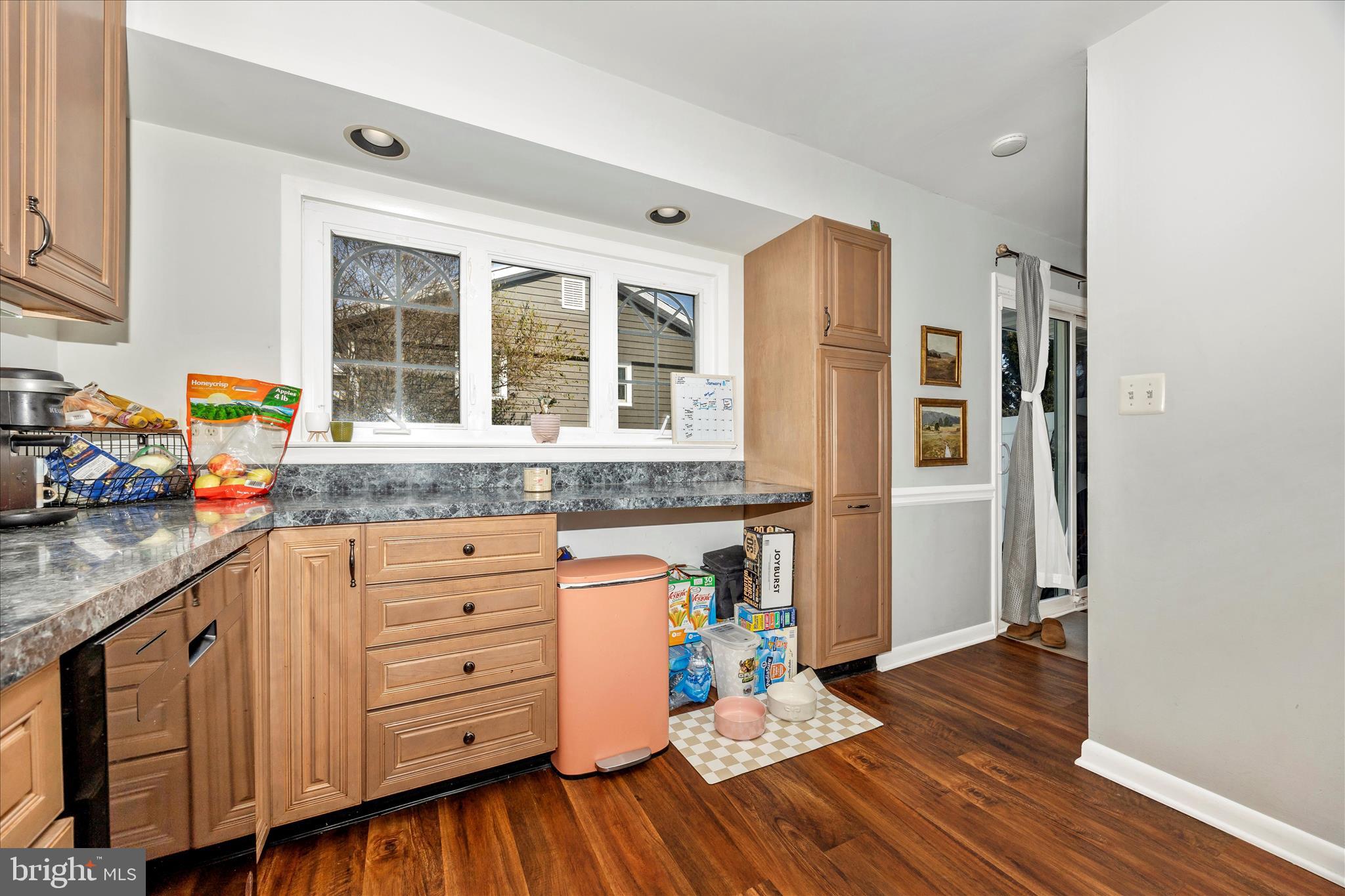 439 Center Street Frederick, MD 21701 - Photo 23 of 49 a kitchen with stainless steel appliances granite countertop a refrigerator and wooden cabinets