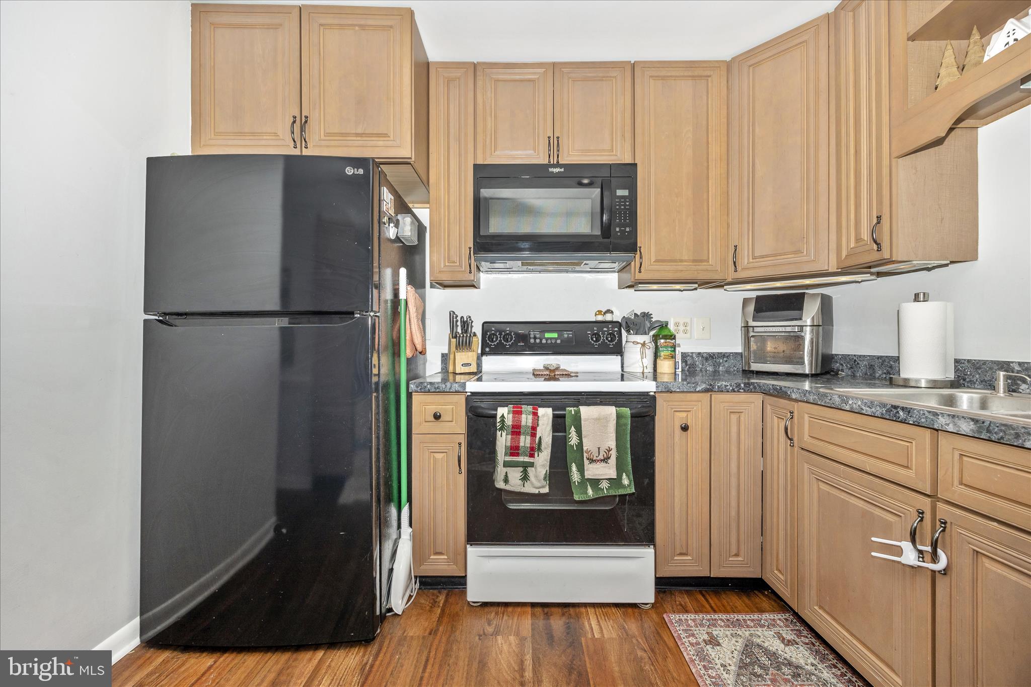 439 Center Street Frederick, MD 21701 - Photo 25 of 49 a kitchen with stainless steel appliances a refrigerator a stove a microwave and cabinets