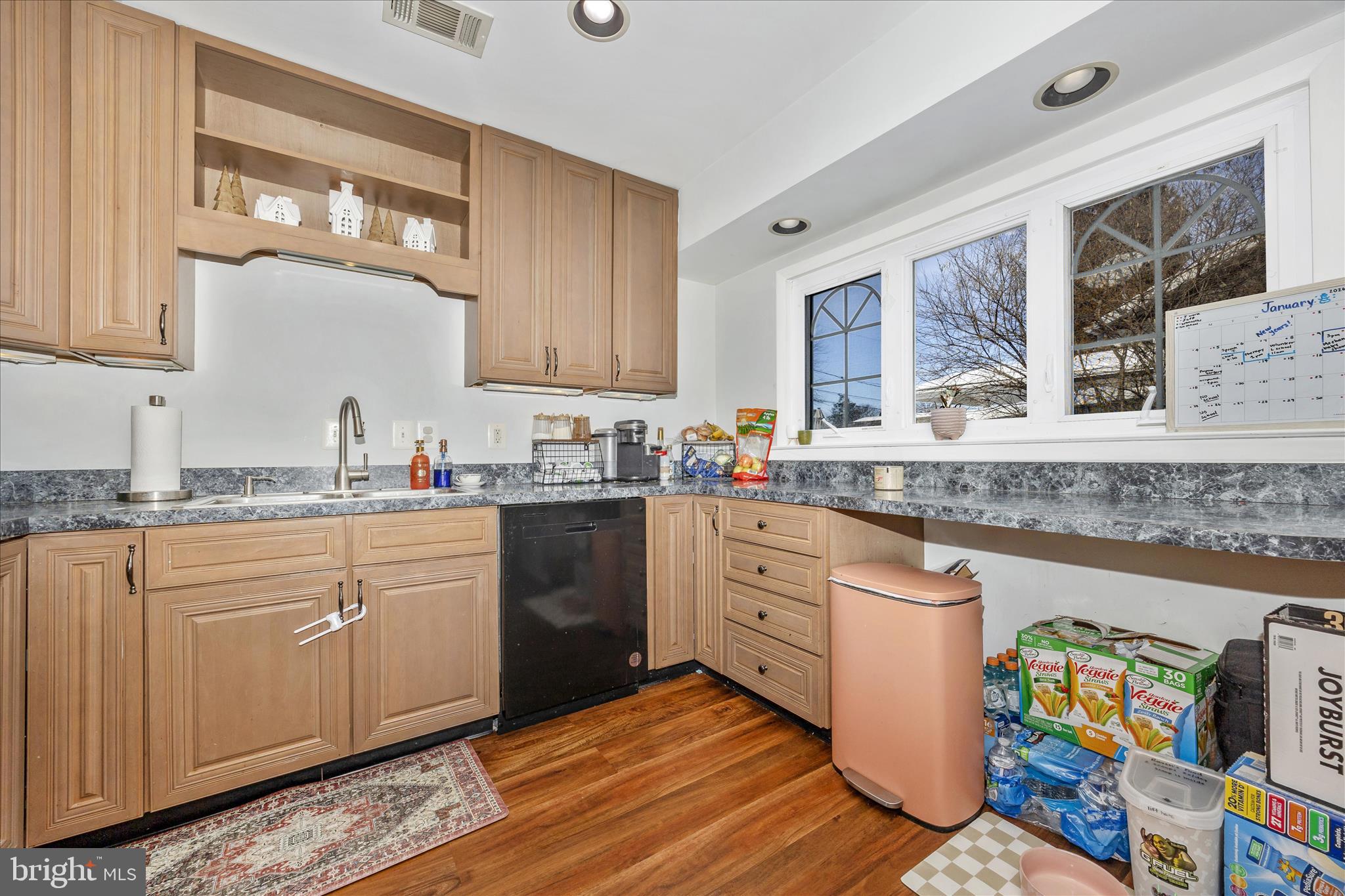439 Center Street Frederick, MD 21701 - Photo 27 of 49 a kitchen with granite countertop a sink cabinets stainless steel appliances and a counter top space