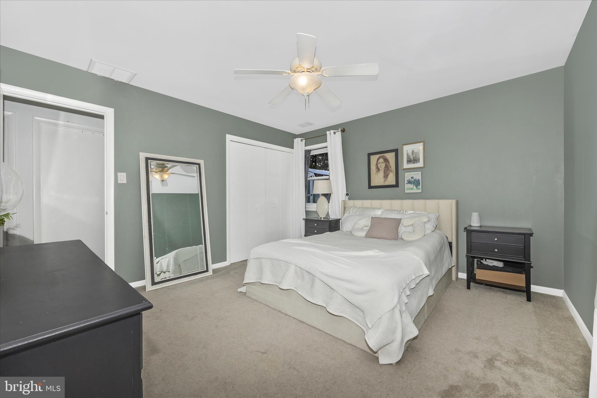 439 Center Street Frederick, MD 21701 - Photo 30 of 49 a spacious bedroom with a bed and a chandelier