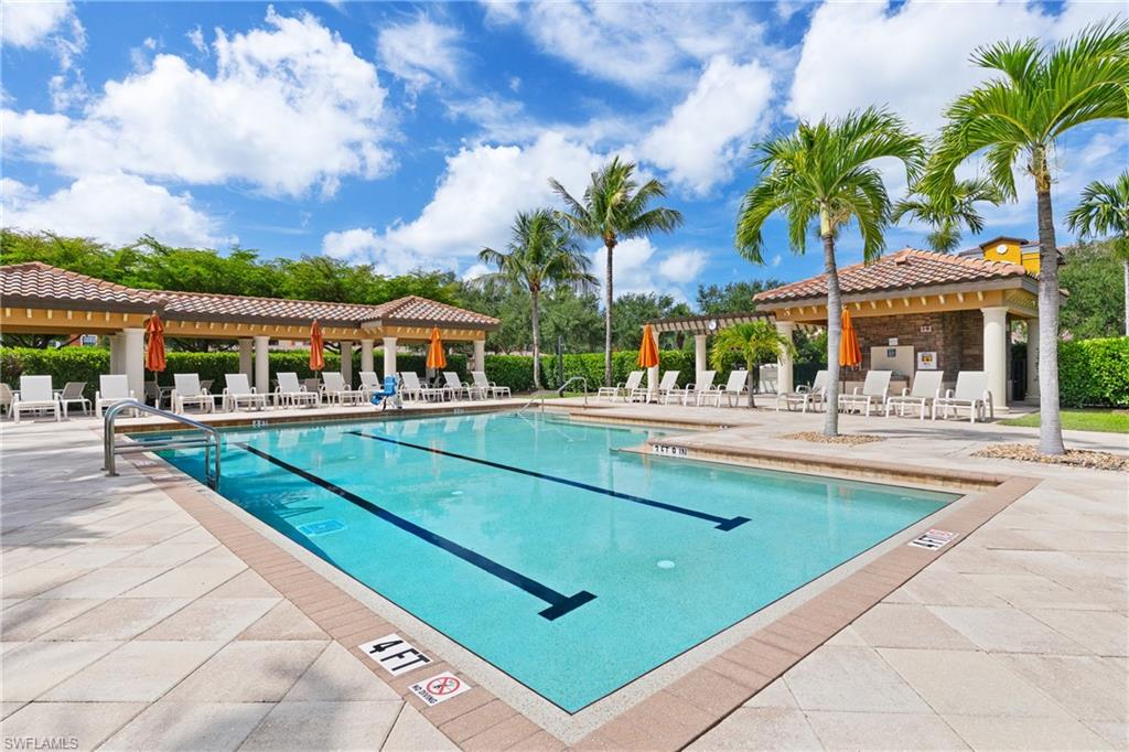9715 Acqua Court, Unit 116 Naples, FL 34113 - Photo 19 of 43 a swimming pool with outdoor seating and yard