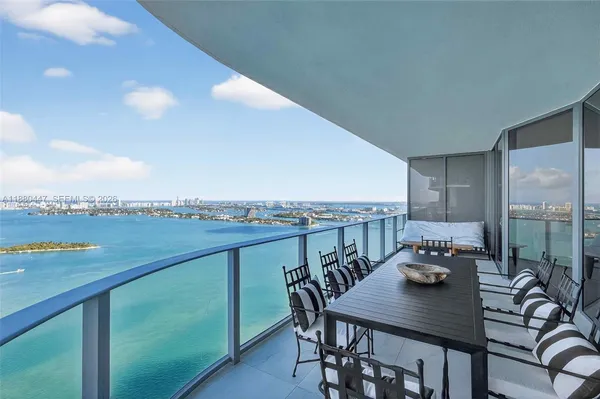 a view of a balcony with table and chairs