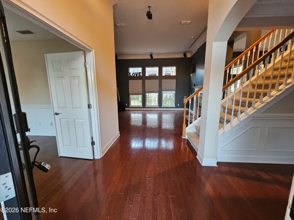 a kitchen with stainless steel appliances granite countertop a stove a refrigerator a sink a stove and island with wooden floor