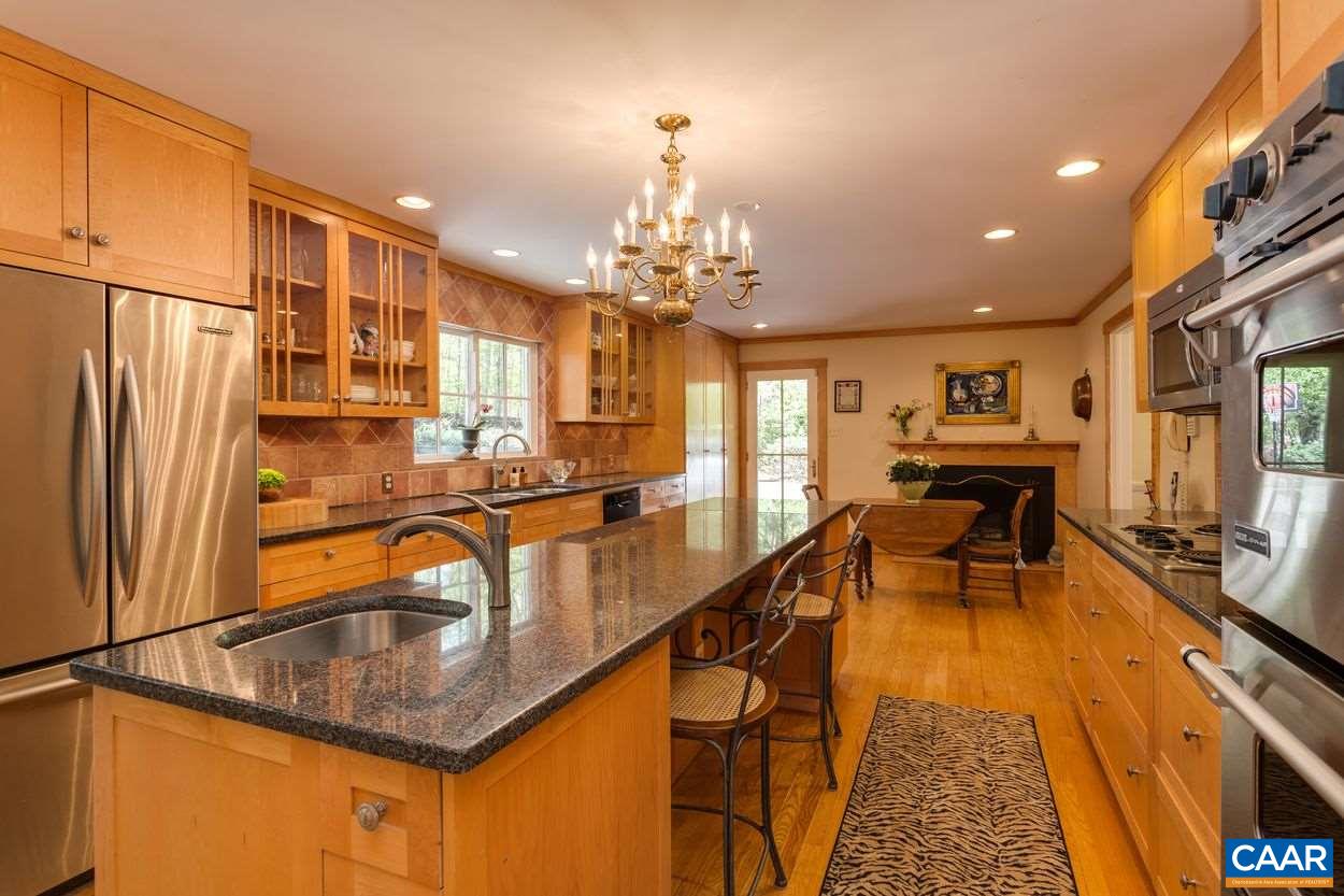 788 Tanglewood Road Charlottesville, VA 22901 - Photo 12 of 39 a kitchen with stainless steel appliances granite countertop sink stove refrigerator and cabinets