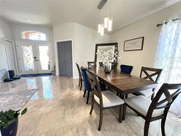 a view of a dining room with furniture and chandelier