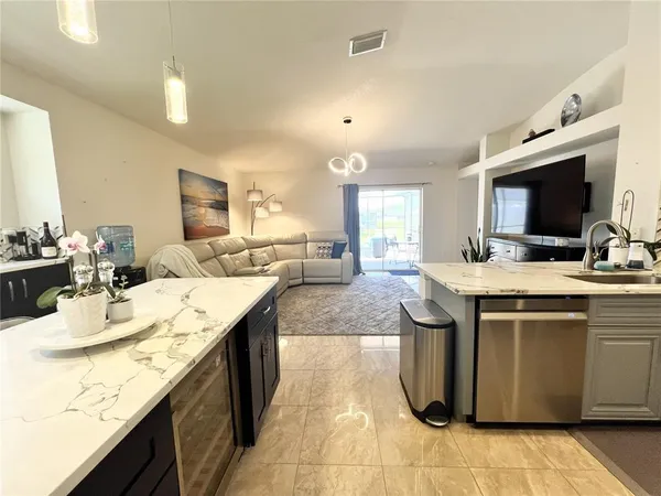 a kitchen with kitchen island granite countertop a sink counter top space and cabinets