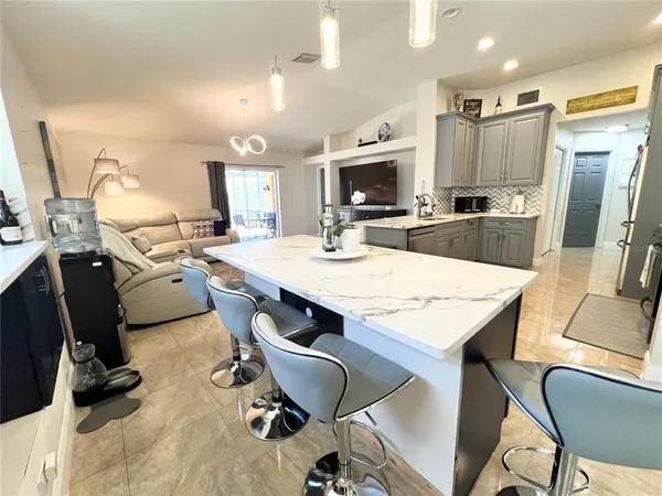 a large kitchen with a table and chairs