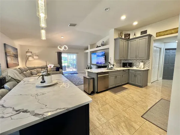 a kitchen with kitchen island a sink appliances and cabinets