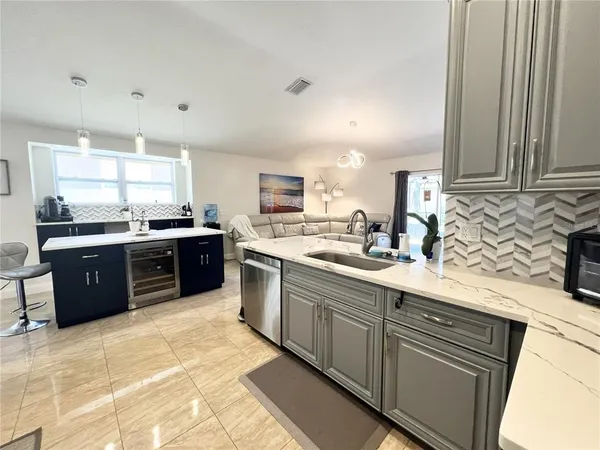 a kitchen with stainless steel appliances granite countertop a sink counter space cabinets and a large window
