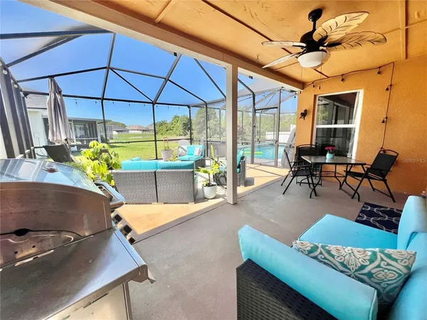 a living room with furniture and floor to ceiling window