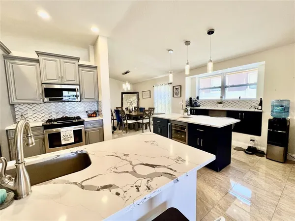 a kitchen with stainless steel appliances kitchen island granite countertop a sink and cabinets