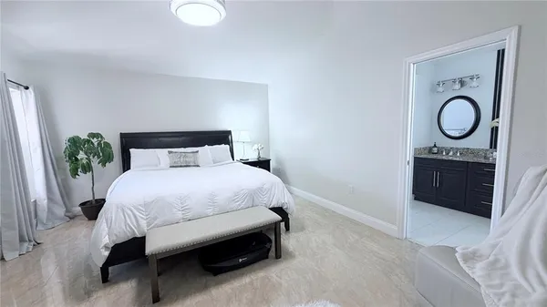 a bedroom with a bed and a potted plant