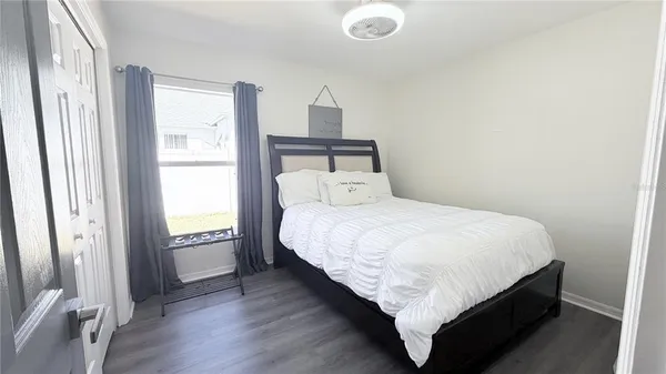 a bed sitting in a bedroom next to a window