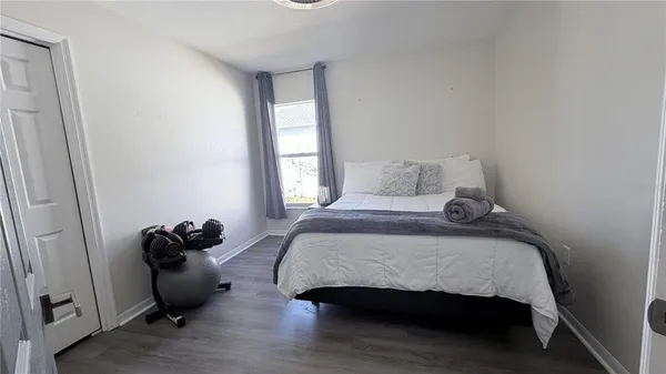 a bedroom with a bed and a chair