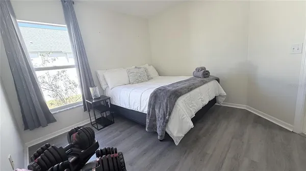 a bed sitting in a bedroom next to a window