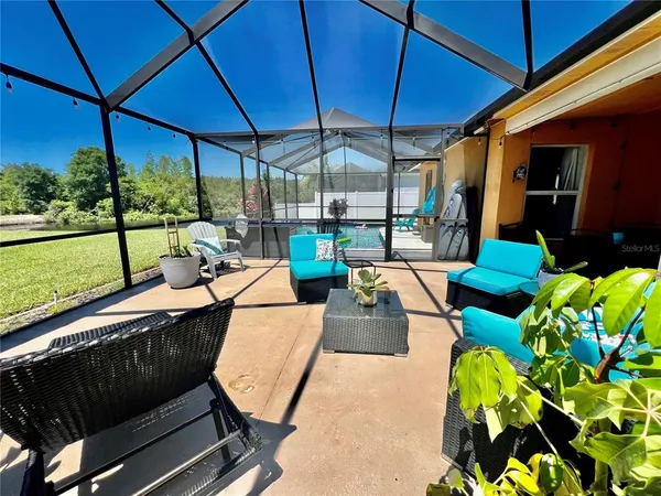 a view of a backyard with sitting area