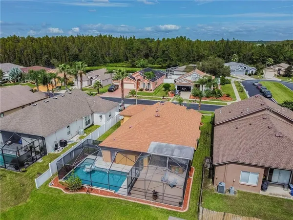 an aerial view of a houses with a swimming pool