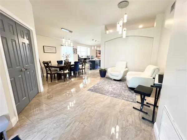 a living room with furniture and a chandelier