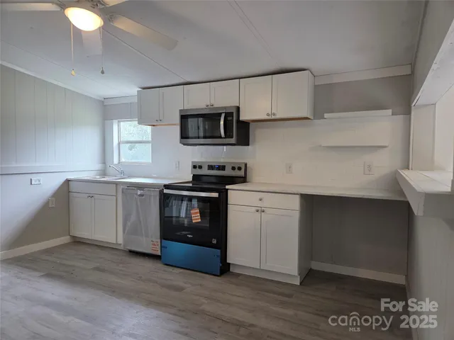 a kitchen with a sink cabinets and stainless steel appliances