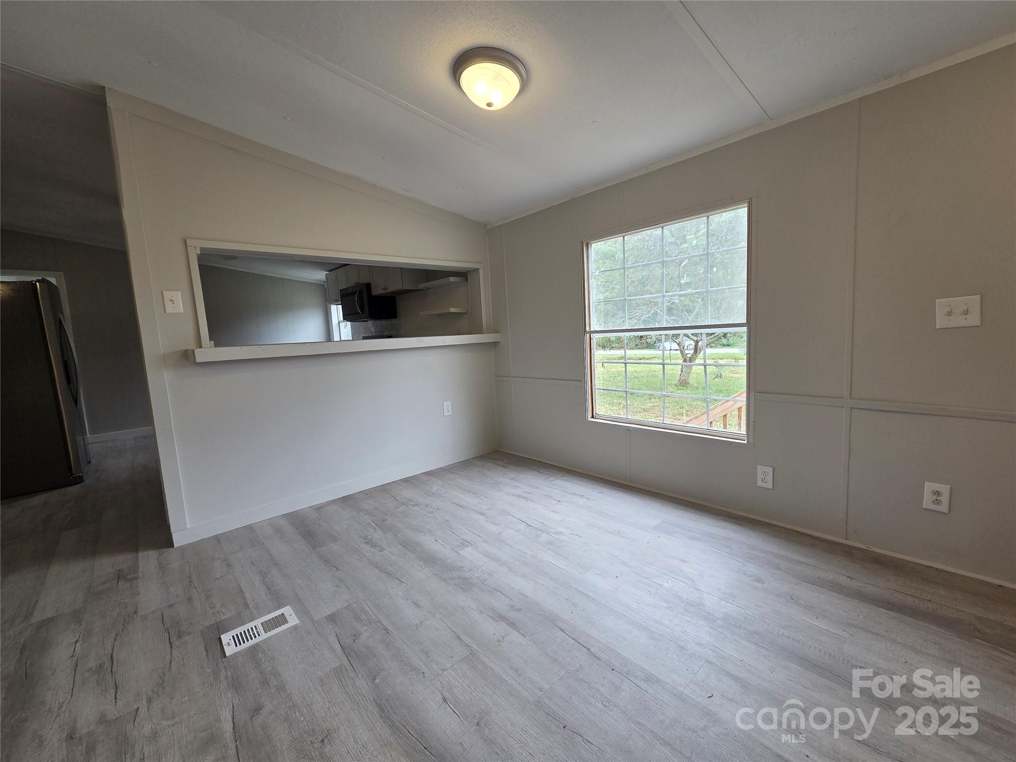 108 State Rd S-46-167 York, SC 29745 - Photo 4 of 19 a view of an empty room with window and wooden floor