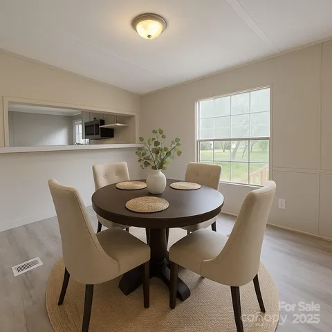 a view of a dining room with furniture and window