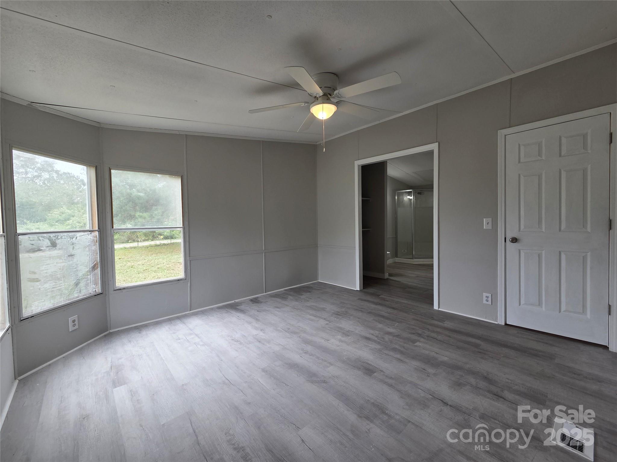 108 State Rd S-46-167 York, SC 29745 - Photo 7 of 19 an empty room with wooden floor and windows