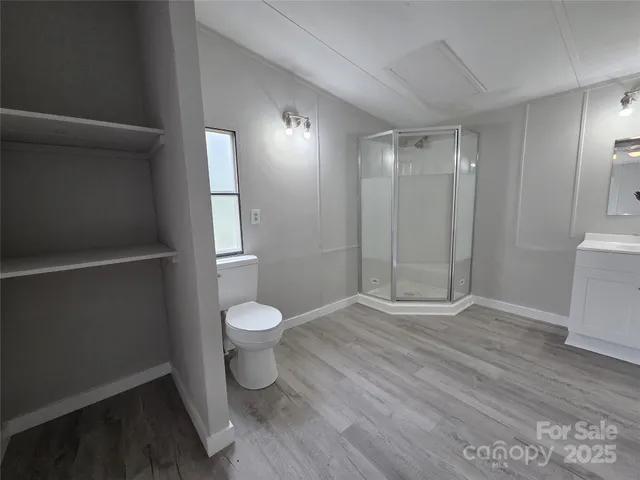 a bathroom with a toilet and a shower