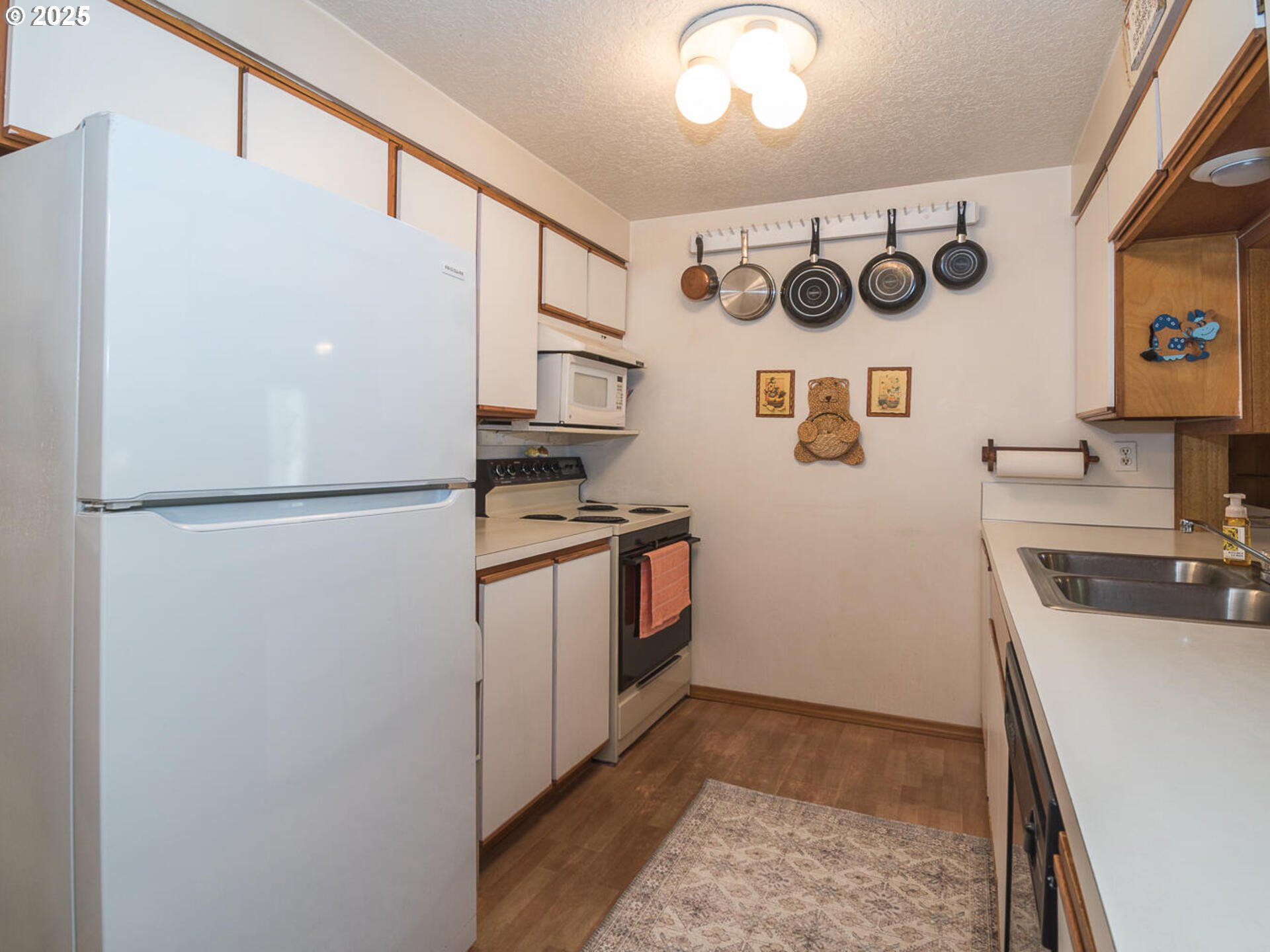 2068 Northeast Juniper Court Gresham, OR 97030 - Photo 12 of 42 a kitchen with a refrigerator and a sink