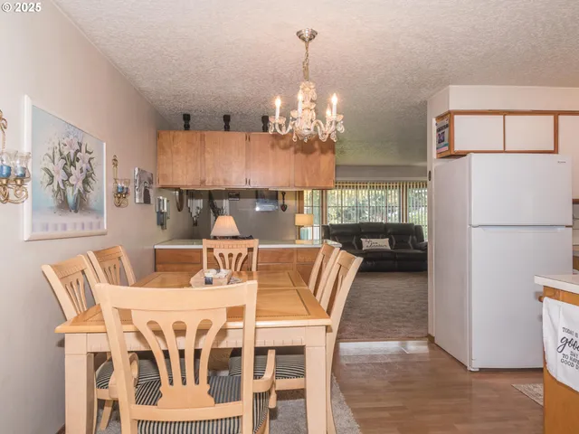 a view of a dining room with furniture and chandelier