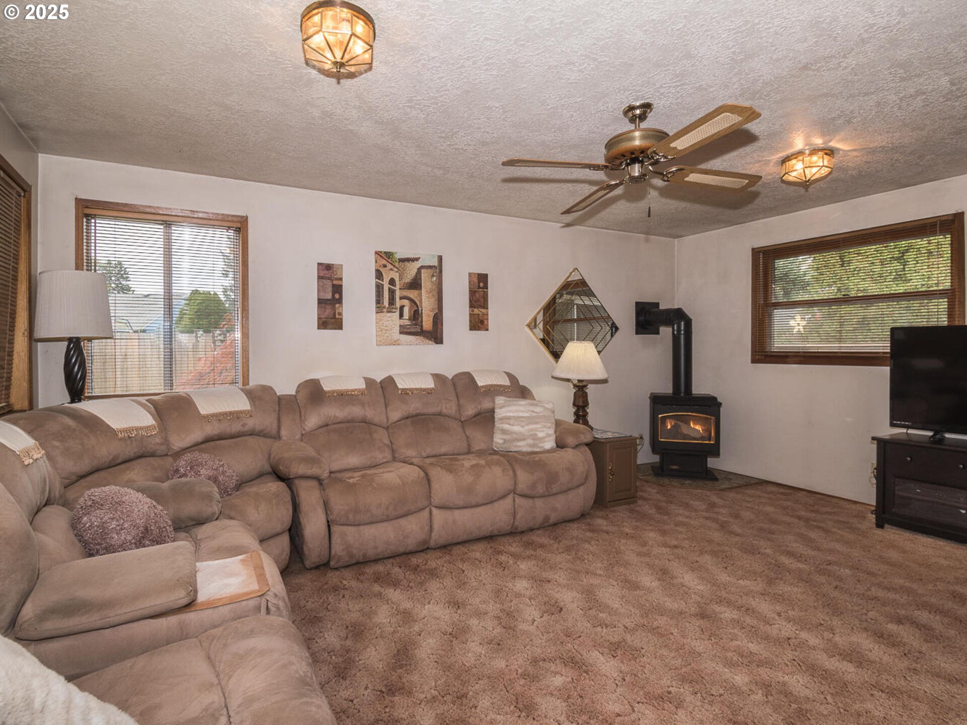 2068 Northeast Juniper Court Gresham, OR 97030 - Photo 18 of 42 a living room with furniture and a flat screen tv