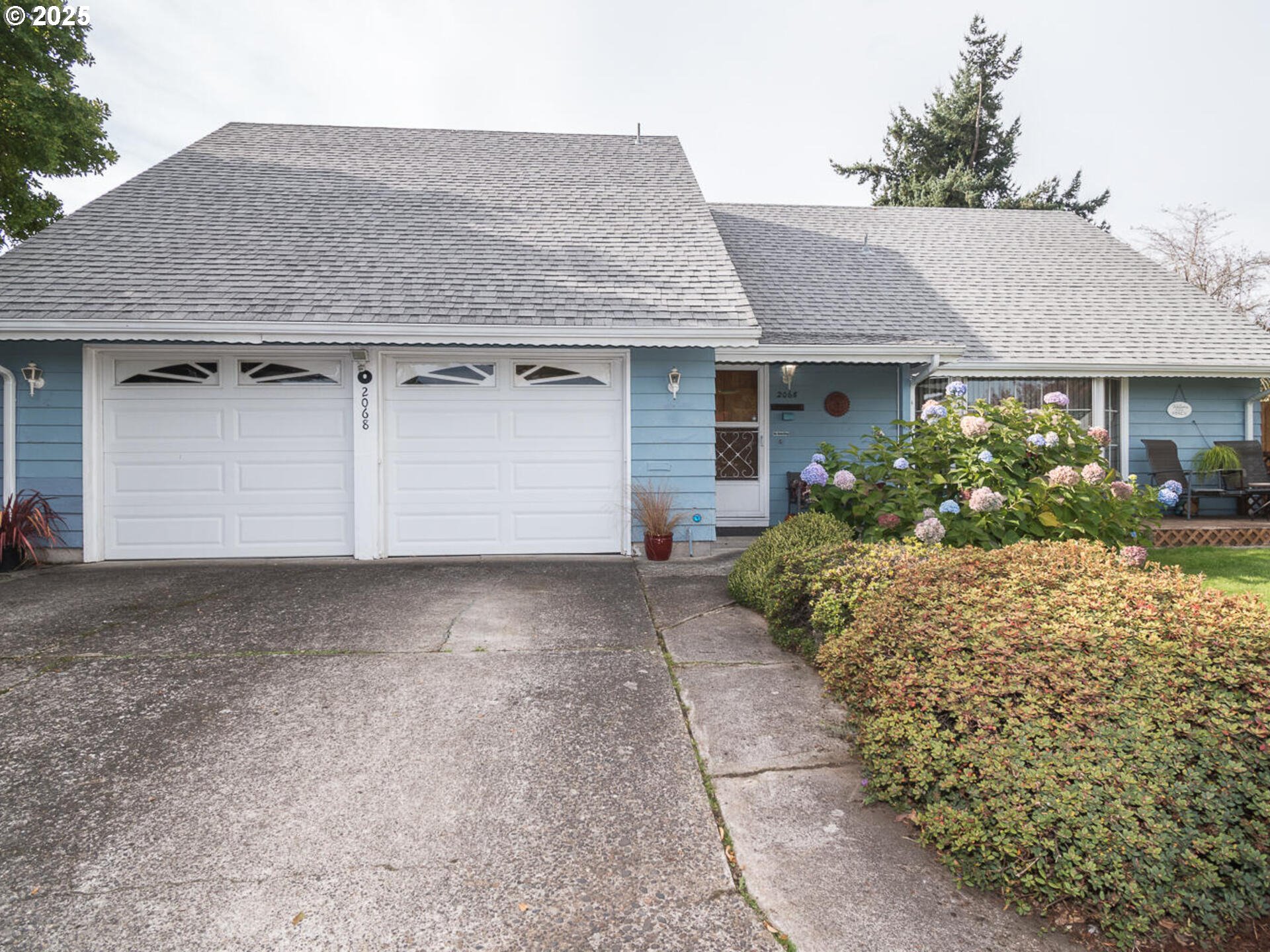 2068 Northeast Juniper Court Gresham, OR 97030 - Photo 2 of 42 a front view of a house with garden