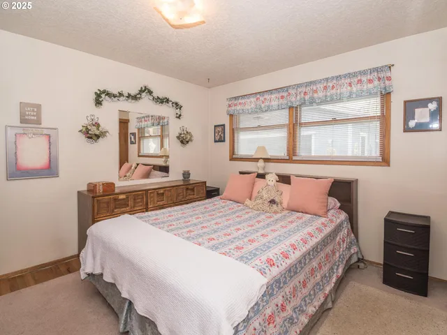 a bedroom with a bed and a table