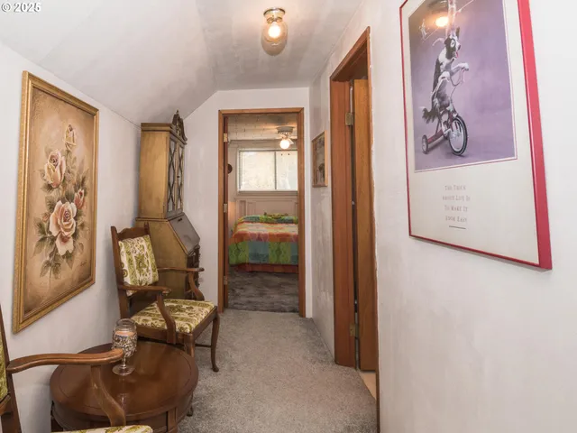 a living room with furniture and a painting on the wall