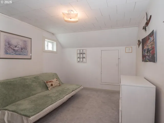 a living room with furniture and a baby crib