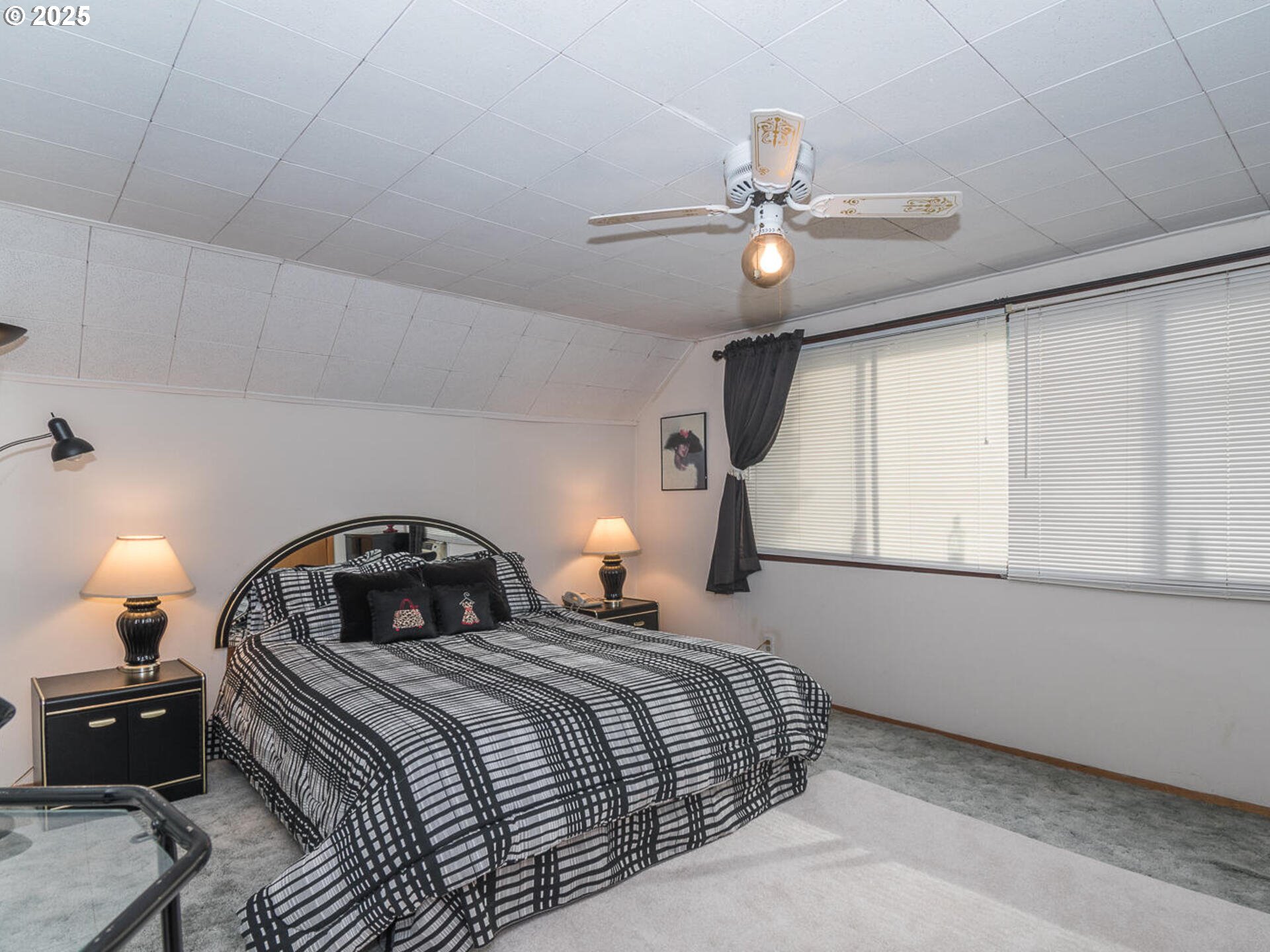 2068 Northeast Juniper Court Gresham, OR 97030 - Photo 28 of 42 a bedroom with a bed and a chandelier