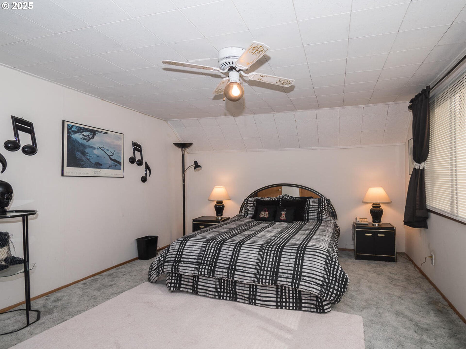 2068 Northeast Juniper Court Gresham, OR 97030 - Photo 29 of 42 a bedroom with a bed and a chandelier