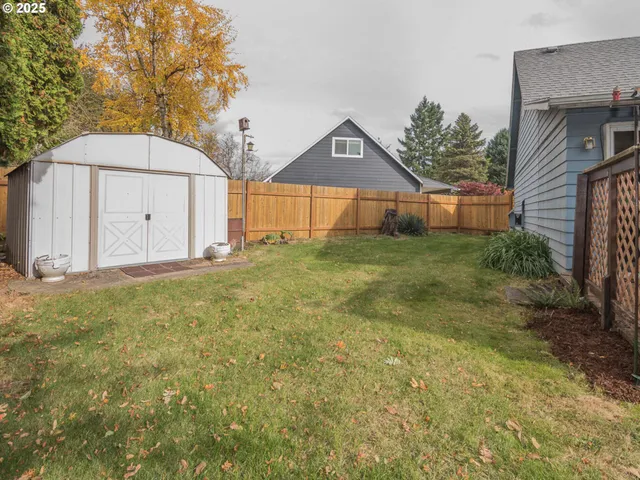 a backyard of a house with plants and trees