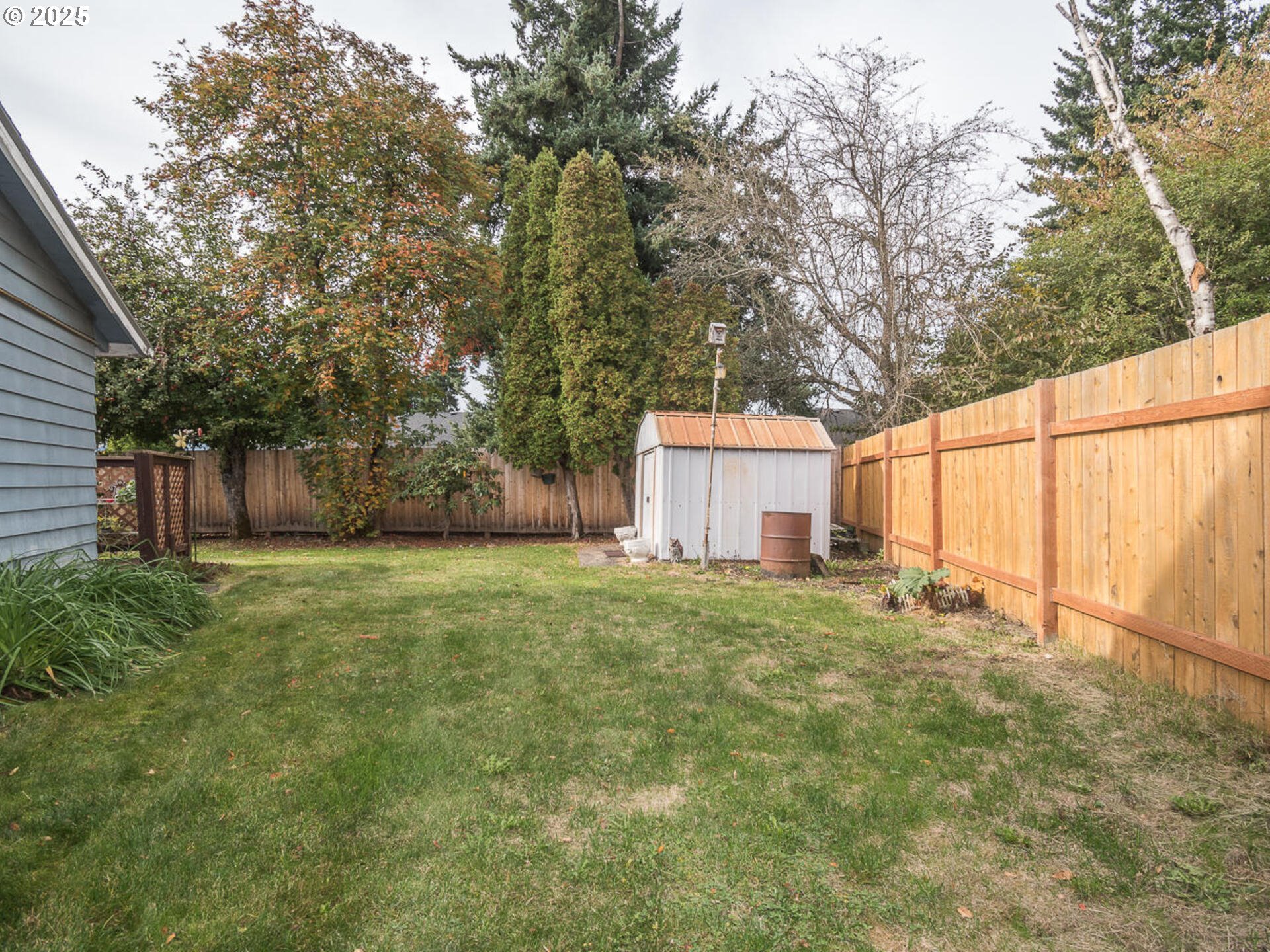 2068 Northeast Juniper Court Gresham, OR 97030 - Photo 38 of 42 a backyard of a house with plants and trees