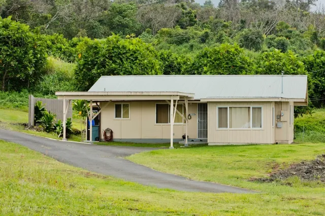 an aerial view of a house with garden space and street view