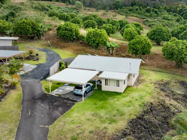 an aerial view of a house with a yard