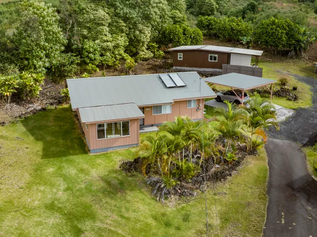 an aerial view of a house with a yard