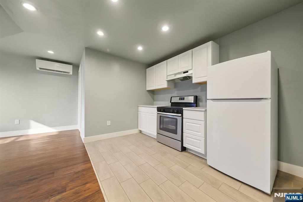 297 West Runyon Street Newark, NJ 07108 - Photo 13 of 14 a kitchen with granite countertop a refrigerator and a stove top oven