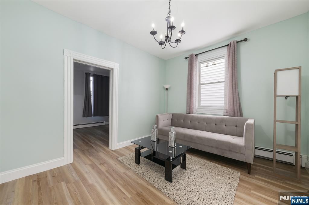 297 West Runyon Street Newark, NJ 07108 - Photo 3 of 14 a living room with furniture and a chandelier