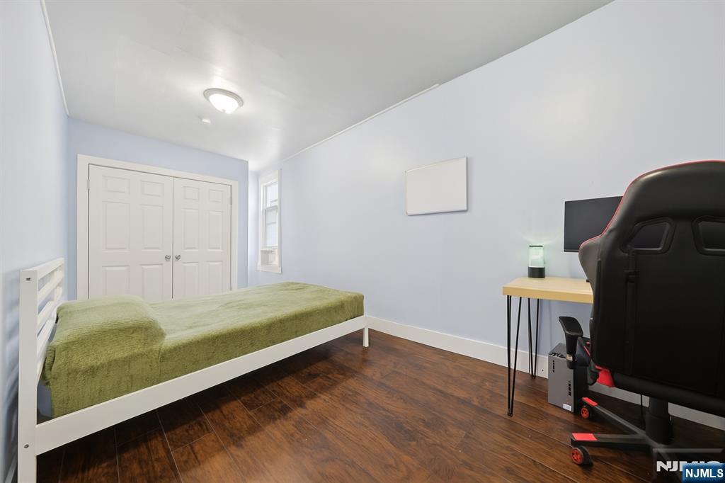 297 West Runyon Street Newark, NJ 07108 - Photo 6 of 14 a bed room with a bed and a window