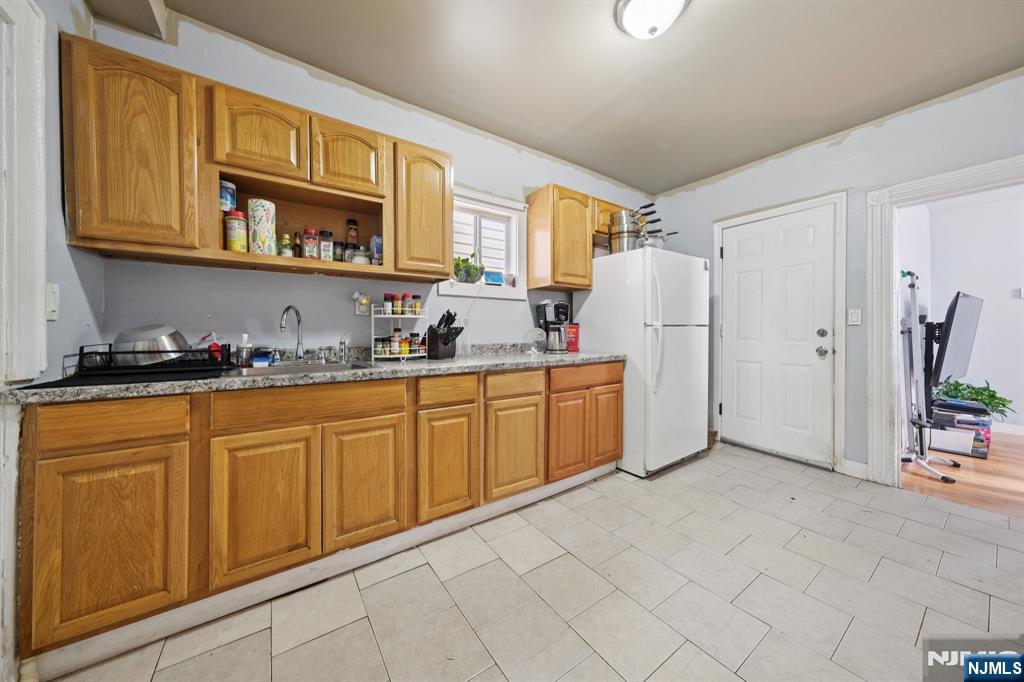 297 West Runyon Street Newark, NJ 07108 - Photo 10 of 14 a kitchen with stainless steel appliances a refrigerator and cabinets