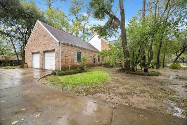 a view of a house with a yard and large tree