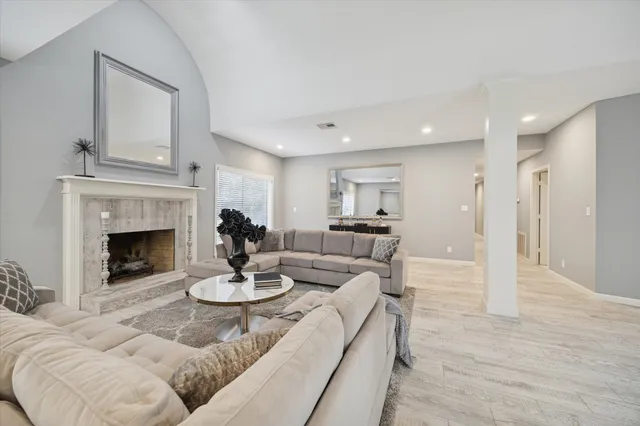 a living room with furniture and a fireplace