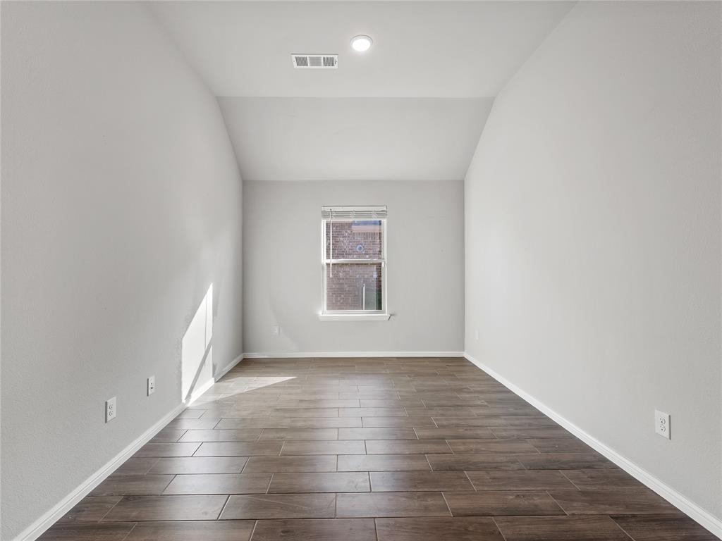 3301 Redbud Flower Trail Venus, TX 76084 - Photo 13 of 28 an empty room with wooden floor and windows