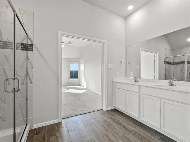 a bathroom with a double vanity sink and mirror